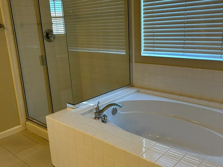 Spacious master bathroom, shower and bath tub, freshly painted interiors