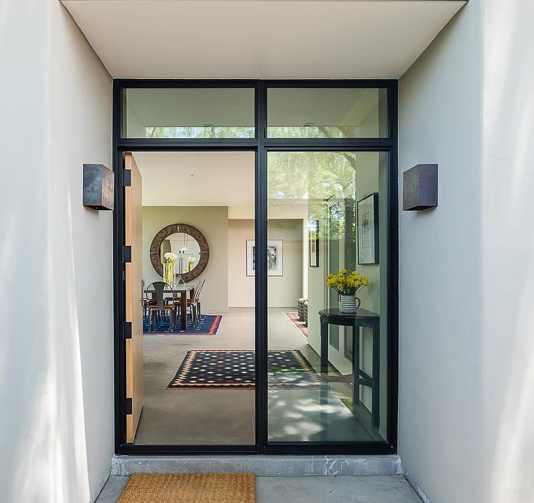 Front entry, shaded by massive mesquite tree. Note the steel trim above door.