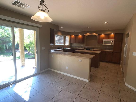 Great floor plan with huge kitchen, breakfast bar, dining area and tons of storage! Fully fenced backyard with mature landscaping and covered patio.