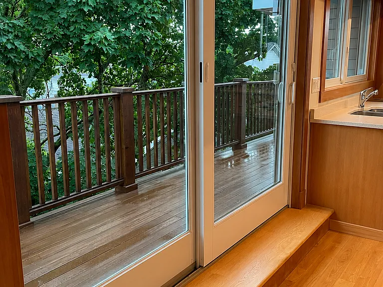 Deck off kitchen overlook side yard area