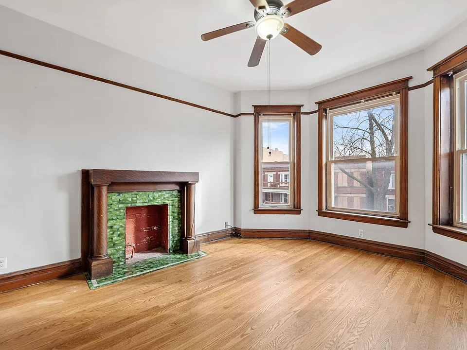 Beautiful natural light filling the Living Room with decorative fireplace and ceiling fan.