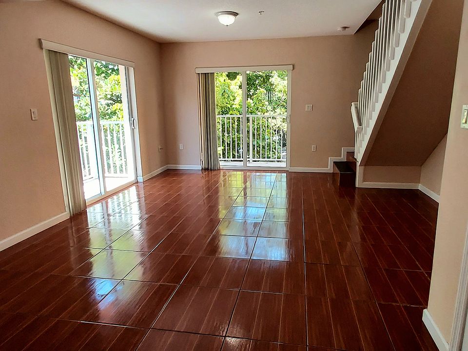 large living room with 2 balconies with garden and water views