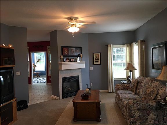 Living room with see thru fire place. Leads into Hearth room.