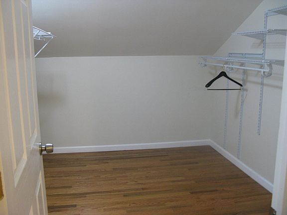 Walk in closet with shelving on both sides.