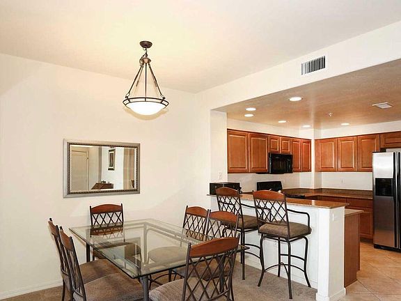 Dining room and kitchen counter; granite slab counter in kitchen. Stainless steel kitchen appliances.