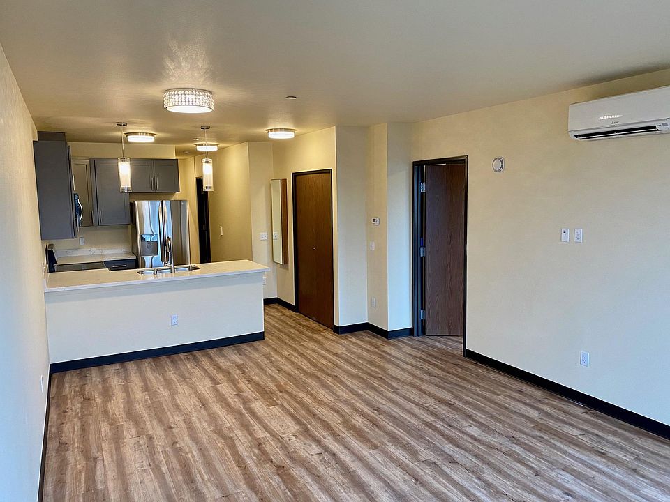 Open solution, kitchen and living room. Mitsubishi ac unit on wall.