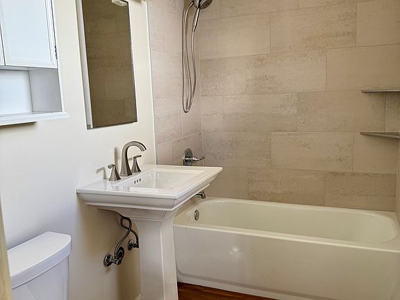 Be the first to enjoy this totally renovated bathroom with awesome dual shower heads and beautiful ceramic tile bathtub enclosure.