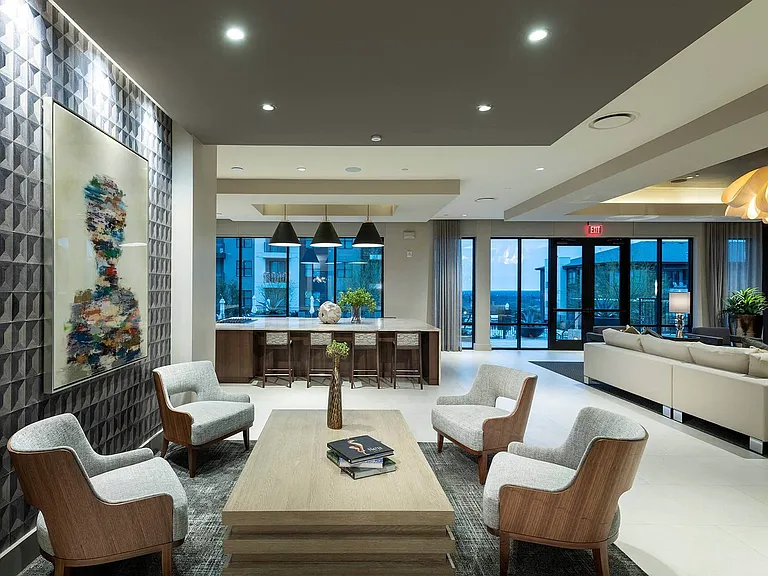 The spacious clubhouse steps out to the outdoor amenity spaces and the pool