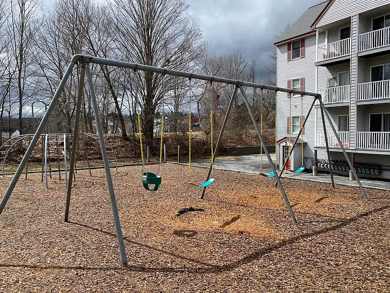 Landmark Apartments' swingset between 7 and 11 Railroad Ave