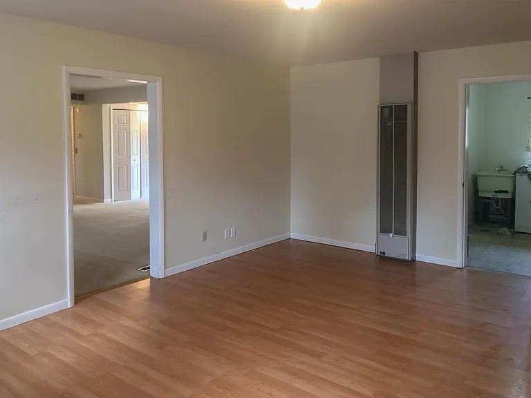 FamilyRoom, view into Living room/dining area, open door on the very right shows the laundry room