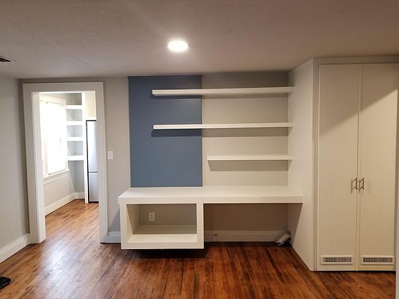 Brand new built-in desk and vertical washer/dryer located in cabinet. This room is spacious and will accommodate a dining room table as well.