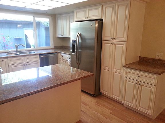 Right side of remodeled kitchen with fridge and pantry