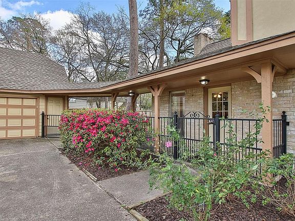 A long wide driveway has convenient covered side entrance to the home.