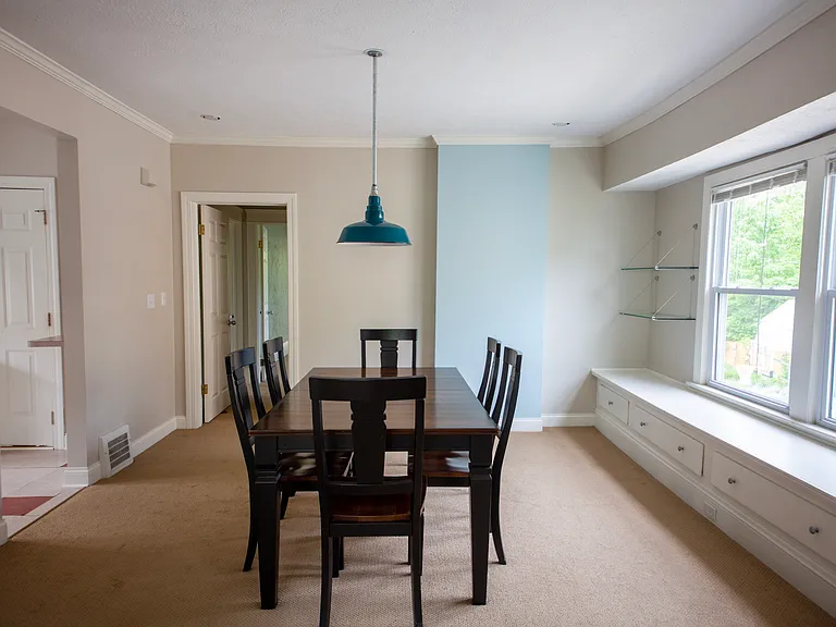 Generous dining room with built-in window seating, perfect for hosting dinners or enjoying morning coffee.