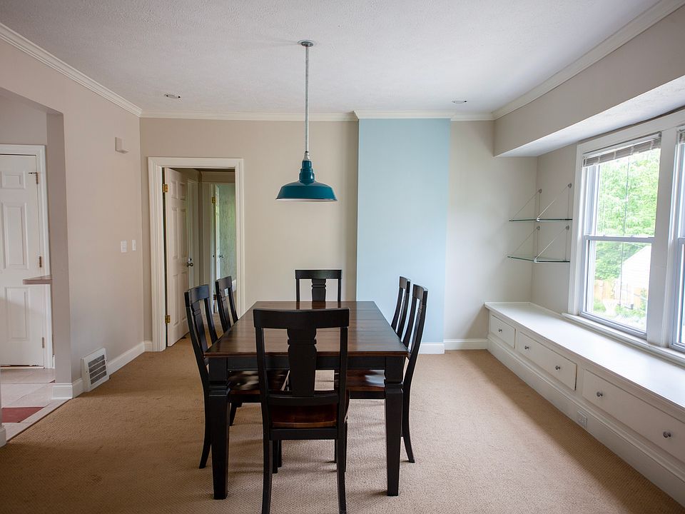 Generous dining room with built-in window seating, perfect for hosting dinners or enjoying morning coffee.