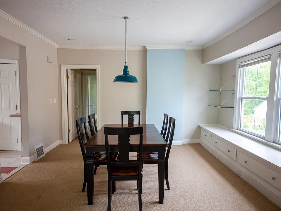 Generous dining room with built-in window seating, perfect for hosting dinners or enjoying morning coffee.