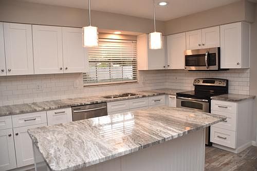 Remodeled kitchen with white shaker cabinets w/soft close drawers and a great island for entertaining. .