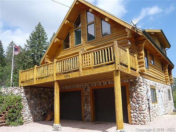 River rock siding * entry to the basement through the garage on