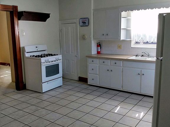 TILED FLOOR. CABINETS.