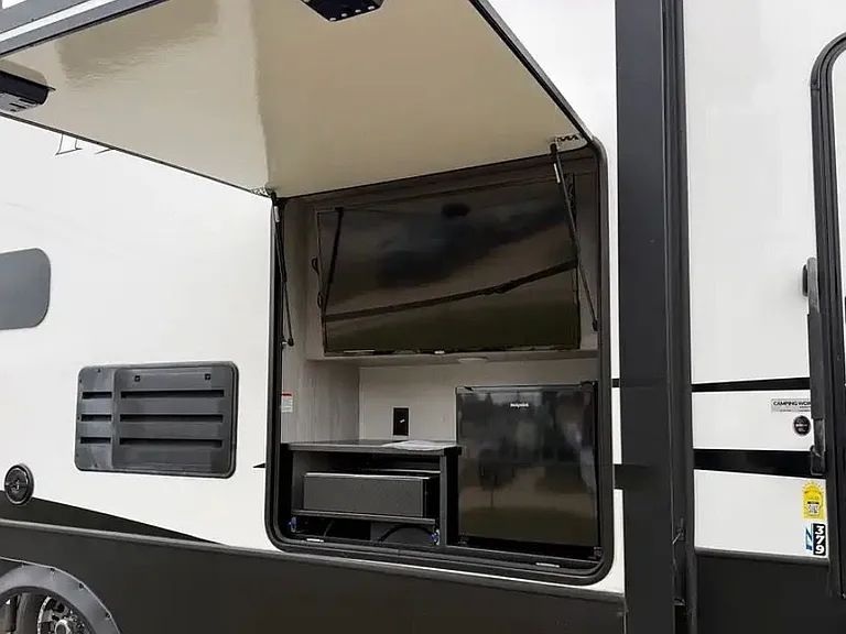 outdoor entertainment area w/ TV and mini fridge