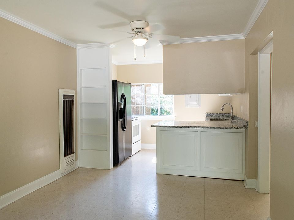 Living Room and Kitchen with granite countertop and barstool dining area