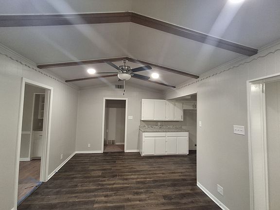 View from hallway of dining/breakfast area. New flooring. Kitchen to right (before appliance installation) To left is entrance to front room. Straight ahead is entrance to bedroom hallway.