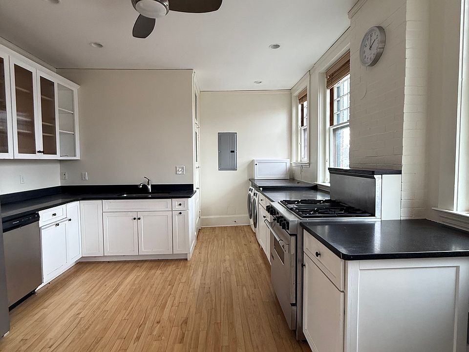 Acces to rear stairs is at the back of kitchen and leads down to basement storage and up to bonus room and private deck.