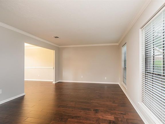 The living space opens to a nice formal dining room with the same beautiful hardwood flooring and crown molding.