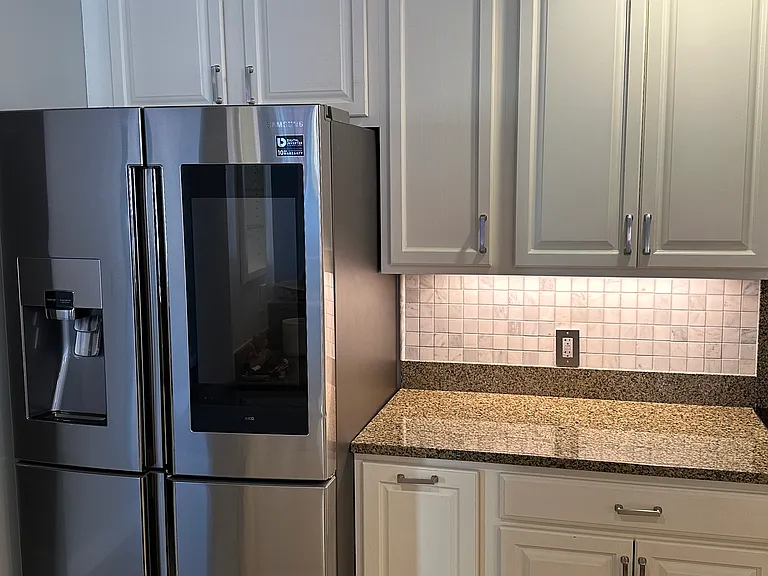 Kitchen with Smart Fridge. Samsung smart fridge has ice maker with water filter. Flex Zone can be used as freezer, refrigerator, or any zone in between.