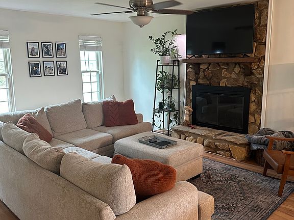 Living room with fireplace and front windows looking into the yard