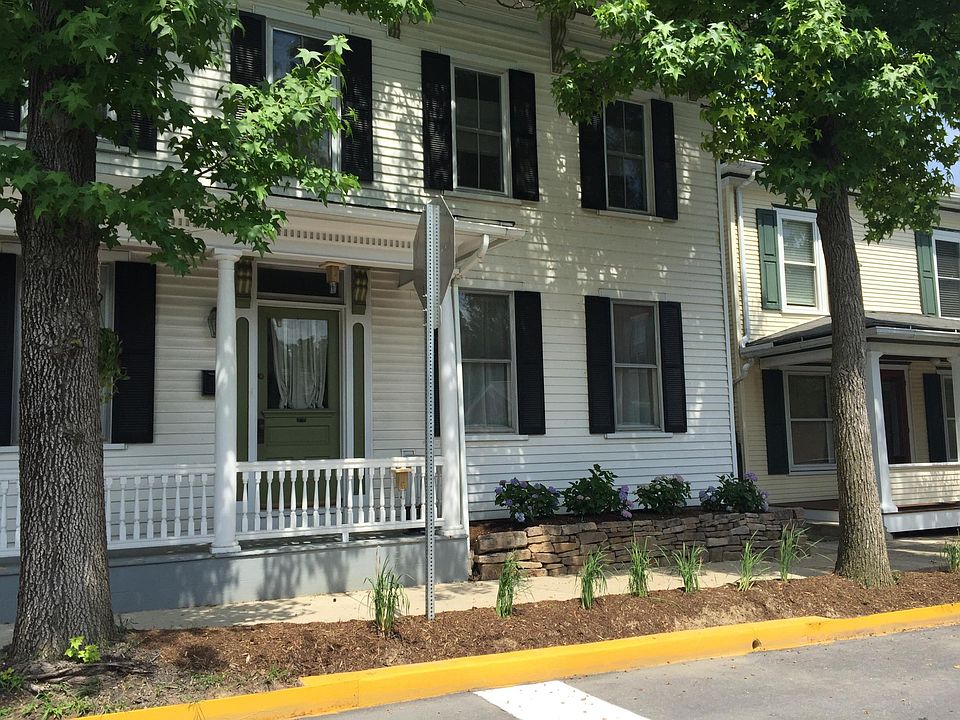 Front of house, corner of 5th and St. Louis. Siberian irises planted along curb with hydrangeas in the raised bed.
