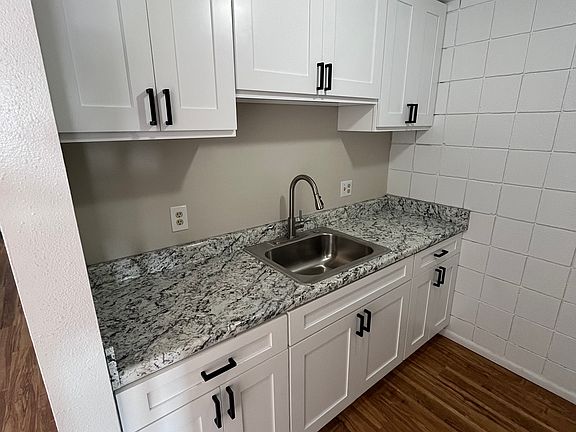 Newly renovated kitchen with brand new cabinets, sink and counters.