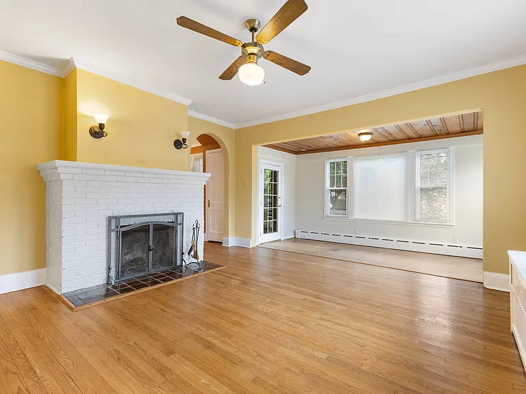 Cozy living area anchored by a beautiful fireplace, perfect for relaxing evenings.