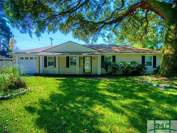 All brick home with newer insulated windows and doors and shaded by a beautiful live oak tree.