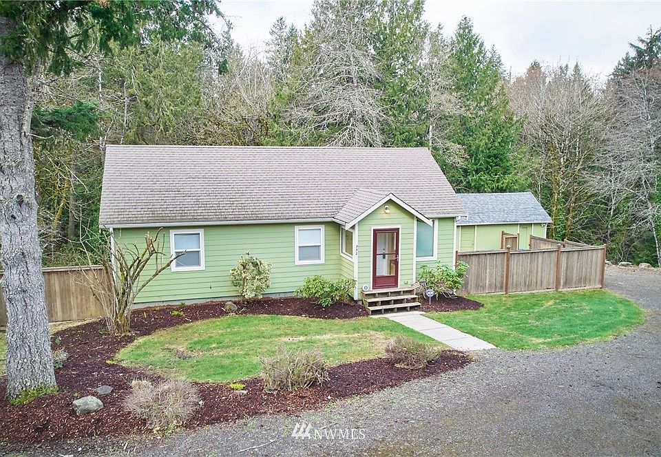 Front view of home. Lots of space, corner lot. Property goes all the way down to the creek. 