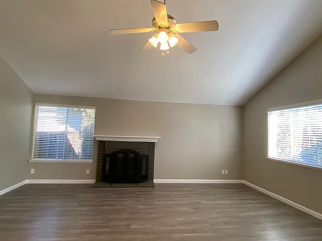 Large living room with vaulted ceilings and wood burning fireplace.