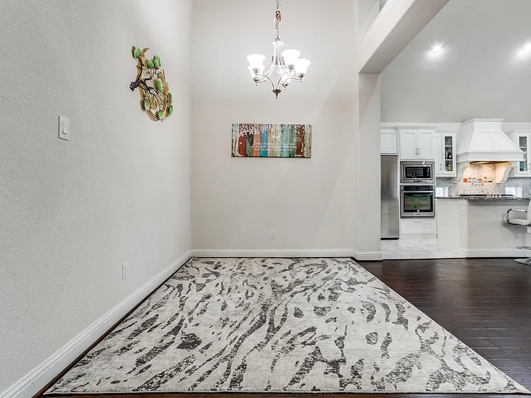 Dining room with an inviting chandelier and dark hardwood / wood-style flooring