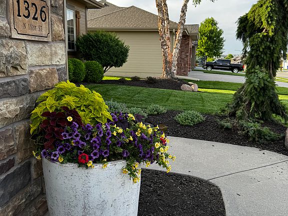 beautiful landscaping surrounds the house