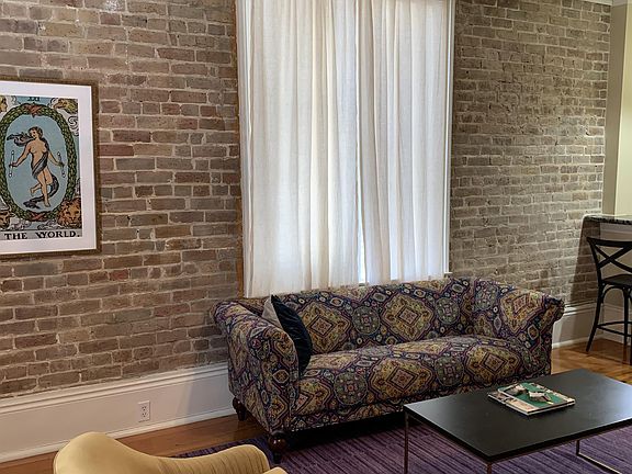 High ceilings, tall baseboards, exposed brick, large windows. Traditional New Orleans style