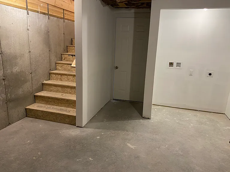 entry from garage to unfinished basement. Washer/dryer hook-ups, stairs to living level