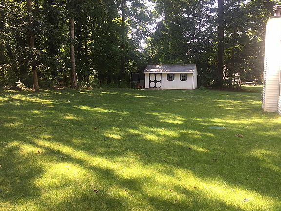 Backyard and shed. Great play space backs to private woods. 