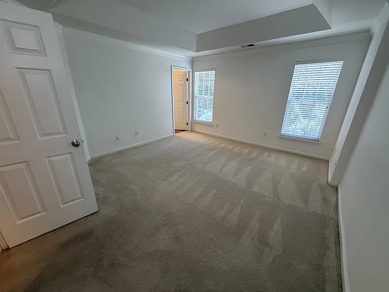 Master Bedroom with tray ceiling, master bathroom and large walkin closet