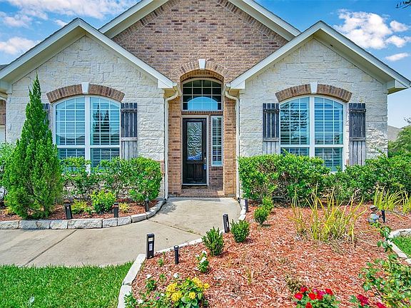 Brick on all sides along with rain gutters, custom built and expertly installed