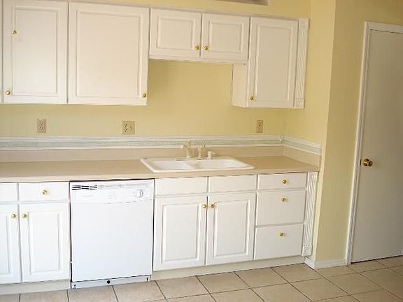 Remodeled kitchen with lots of cabinets, tile flooring and pantry