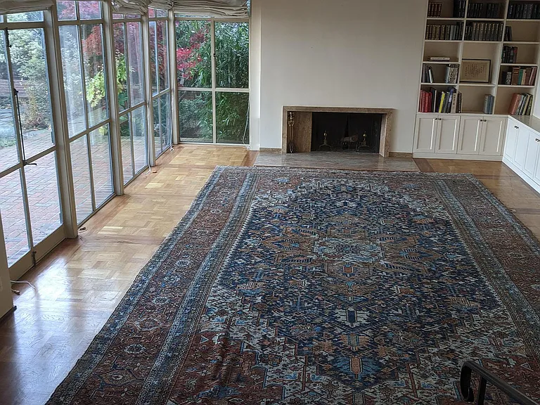 Living room with built in fireplace bookshelves and display sideboard. Rug & books have been removed. View of back garden