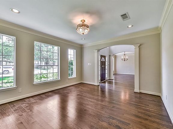 Elegant bright formal den to the right of entry with beautiful hardwood floors can also be used as a study or music room.