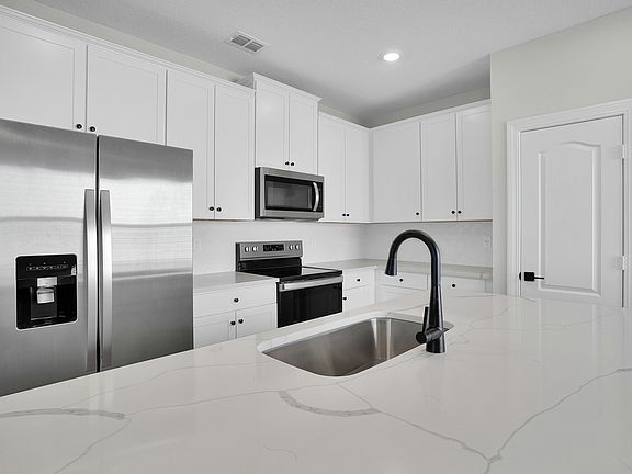The kitchen is chef-ready with stainless steel appliances