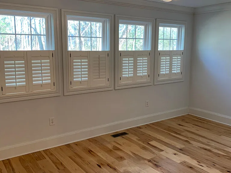 Owner's suite complete with 5" hickory hardwood floors, beautiful windows that back to private rear yard
