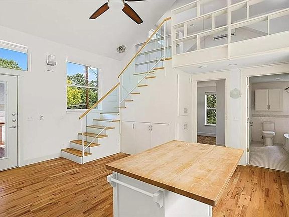 View of kitchen and living area. Loft space seen upstairs.