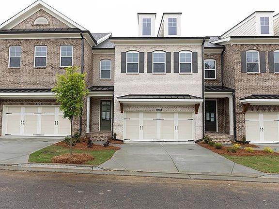 Welcome to Ellington Drive up to eye-appealing brick entry Stockton townhome with covered stoop.